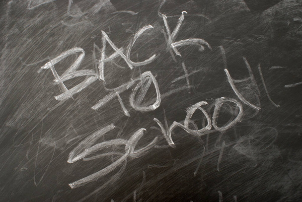 Back to school is written on a chalkboard. - Foto, imagen