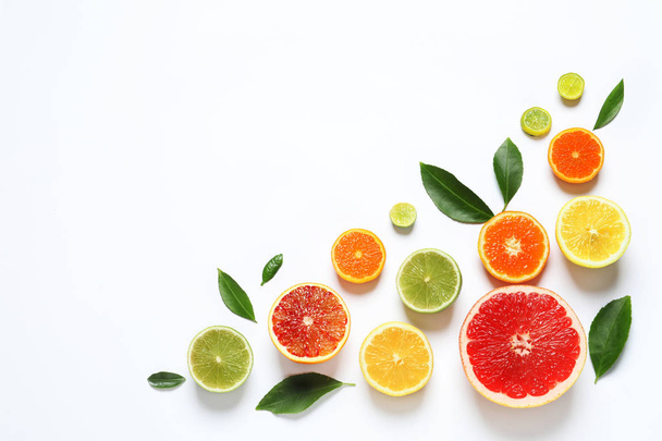 Flat lay composition with different citrus fruits on white background - Foto, Imagen