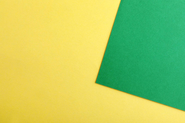 Green and yellow paper sheets as colorful background, top view - Fotoğraf, Görsel