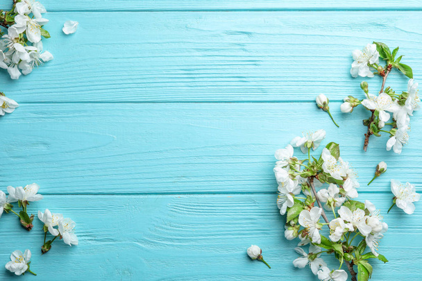 Flat lay composition of beautiful fresh spring flowers on wooden background, space for text - Photo, Image
