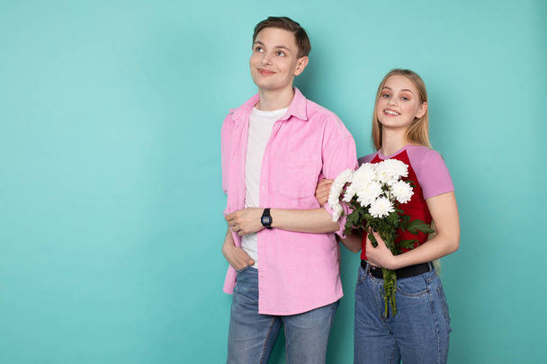 Romantic young couple, handsome man in pink shirt with beautiful cheerful blonde girl - Fotoğraf, Görsel