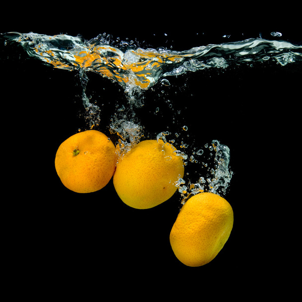 Fresh tangerines dropped into water - Fotografie, Obrázek