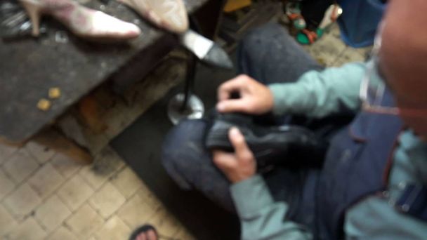 the shoemaker at work.The process of repairing shoes in workshop. - Фото, зображення