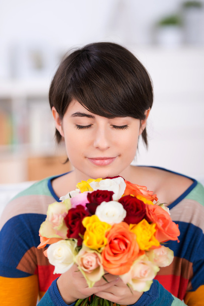 Woman smelling a bunch of roses - Photo, Image
