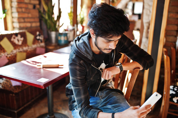 Beard asian man in casual wear sitting indoor cafe and look at h - Photo, image