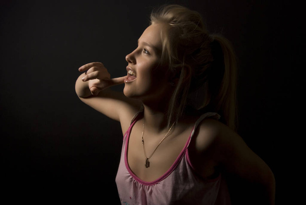 Portrait of a young seductive blonde singing - Foto, afbeelding