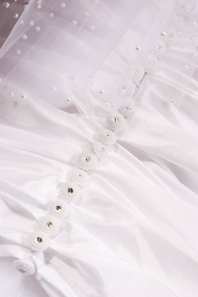 white wedding dress with buttons - 写真・画像