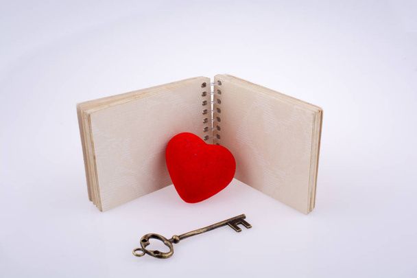 Καρδιά κοντά σε ένα σημειωματάριο - Φωτογραφία, εικόνα
