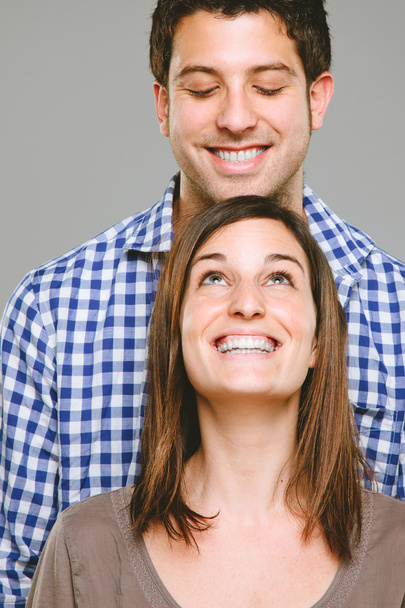 Portrait of a beautiful young couple looking in - Photo, Image