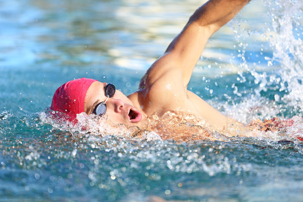 Man swimmer swimming crawl in blue water - Fotoğraf, Görsel
