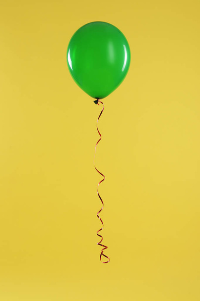 Bright balloon on color background. Celebration time - Foto, afbeelding