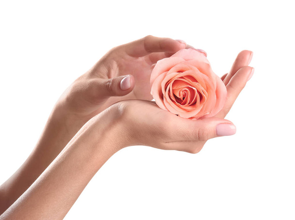 Woman holding rose on white background, closeup. Spa treatment - Foto, Imagen