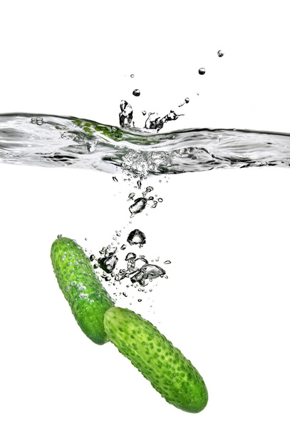 Green cucumbers dropped into water - Zdjęcie, obraz