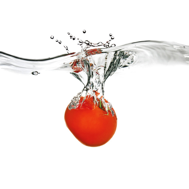 Red tomato dropped into water - Фото, изображение