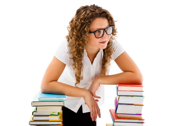 Young woman behind pile of books isolated on white background - Foto, Imagen
