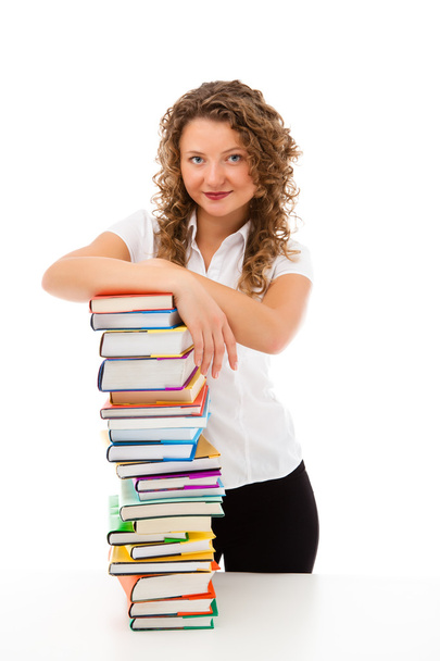 Young woman behind pile of books isolated on white background - Photo, image