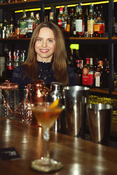 Bartender girl serving coctail to a customer - Photo, image