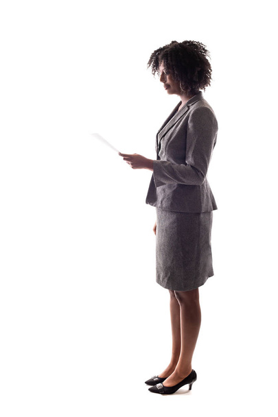 Side View of a Black Businesswoman reading a document, report or resume.  She could also be giving a speech and reading a script like a candidate. - Photo, Image