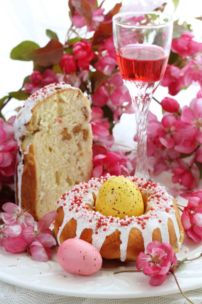 Easter cakes, painted eggs, bouquet and red wine - Фото, изображение