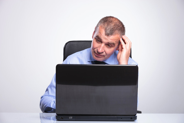 old business man looks puzzled at laptop - Photo, Image