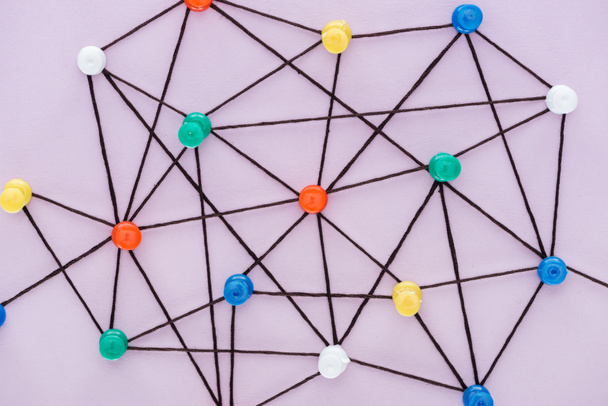 top view of push pins connected with strings Isolated On pink, network concept - Photo, Image