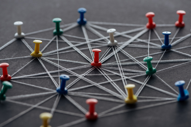 colorful pins connected with strings isolated on grey, network concept - Photo, Image