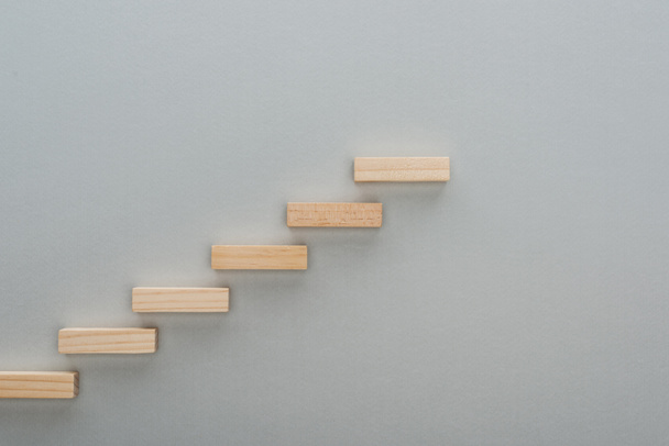 top view of wooden blocks symbolizing career ladder isolated on grey with copy space - Photo, Image