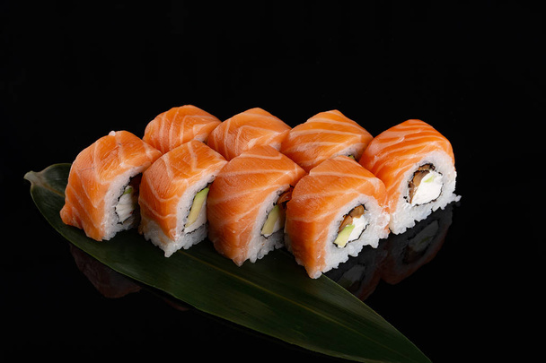 Set of Salmon rolls on a black background - Photo, Image