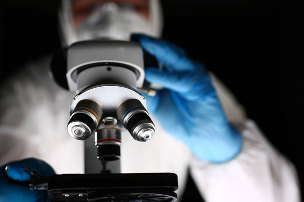 Laboratoriofarmaseutti työskentelee optisella mikroskoopilla
 - Valokuva, kuva