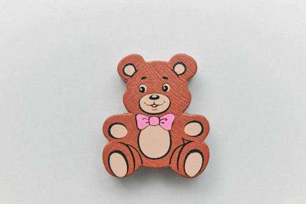 Childrens wooden retro toy Teddy bear alone on a light background. space for text. copy space. - Photo, image