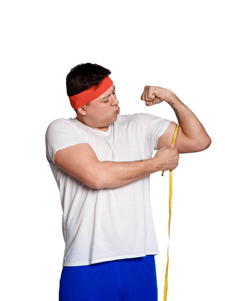 Fat man with a tape measure isolated on white background - Φωτογραφία, εικόνα