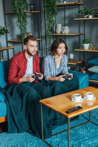 handsome man and attractive woman playing video came in living room  - Photo, Image