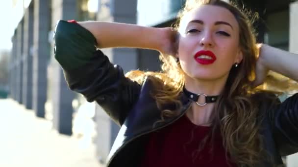 portrait of blonde woman with red lipstick touching her hair in rays of sunset - Video