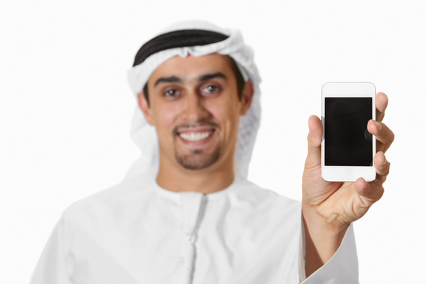 Young smiling Arab with smart phone - Foto, afbeelding