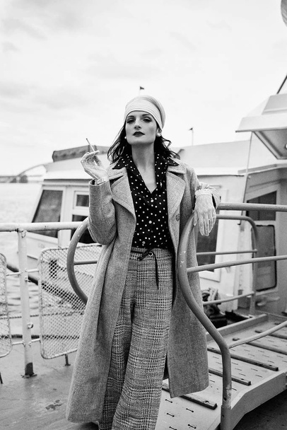 Young stylish woman in retro style clothes smoking  - 写真・画像