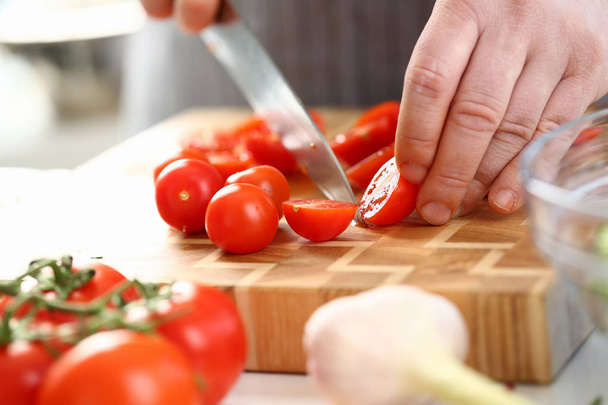 Male Hands Slicing Ripe Cherry Tomato Ingredient - Valokuva, kuva