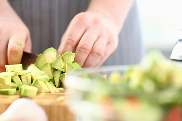 Professional Chef Hands Chopping Exotic Avocado - Foto, afbeelding