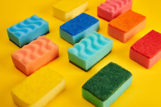 Colorful washing sponges on yellow background  - Фото, изображение