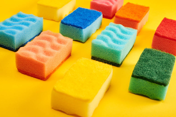 Colorful washing sponges on yellow background  - Fotoğraf, Görsel