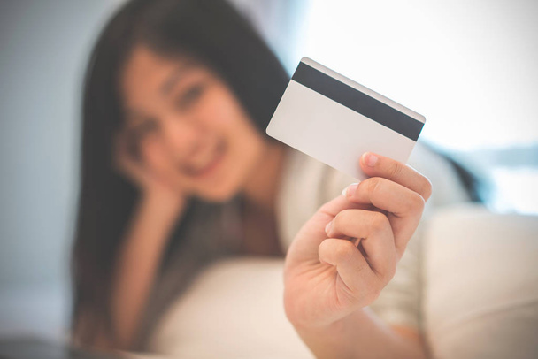 junge Frau arbeitet an einem Laptop und benutzt Kreditkarte, Geschäftigkeit  - Foto, Bild