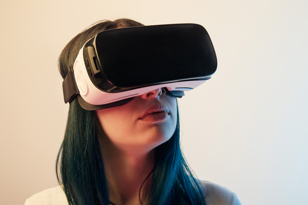 brunette woman wearing virtual reality headset on beige - Photo, Image