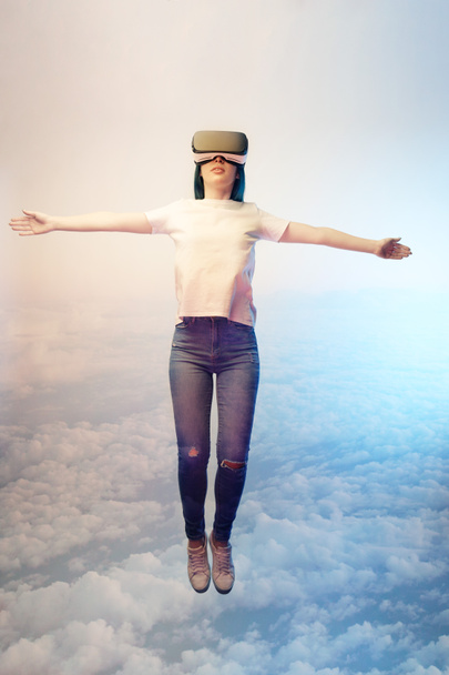 double exposure of brunette woman levitating with outstretched hands near  clouds in sky  - Photo, Image