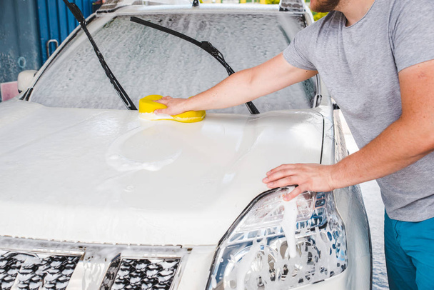 car wash concept. vehicle in soap - Фото, изображение