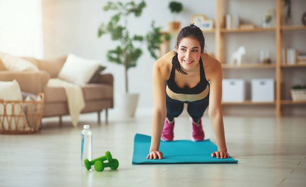 young woman doing fitness and sports at home     - Photo, Image