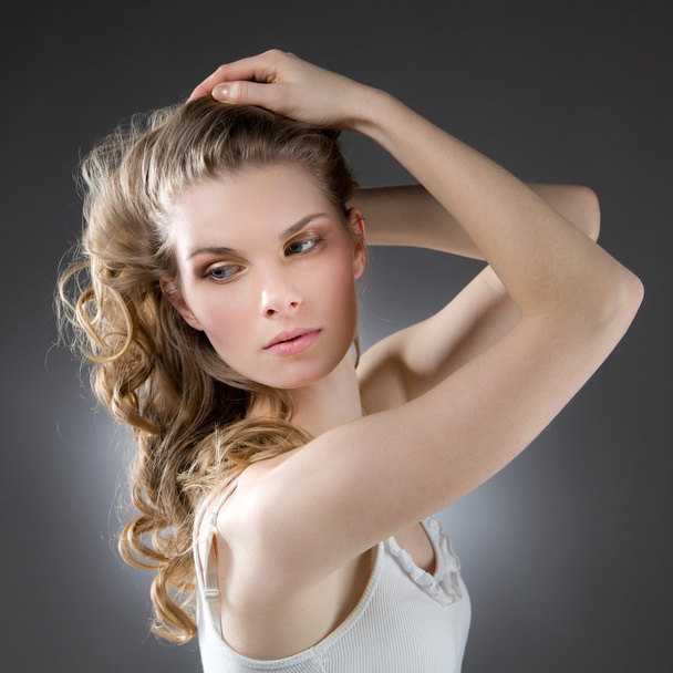 Blonde woman with arms raised, looking sideways - Photo, Image