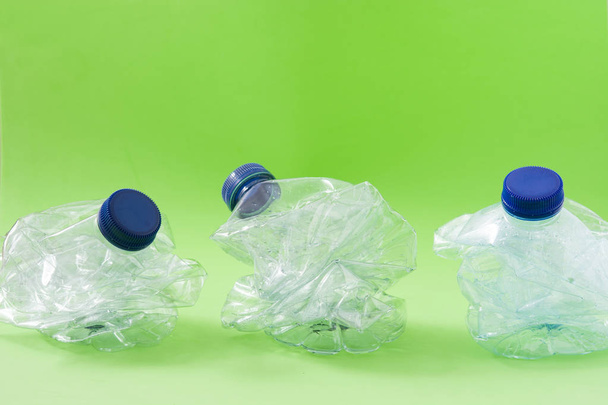 Disposable waste plastic bottles on green background - Photo, Image