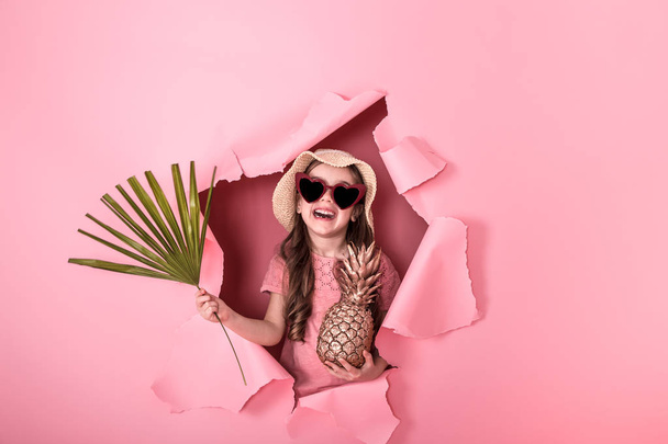 Funny little girl with pineapple on colored background - Foto, immagini