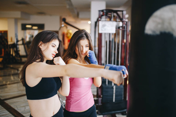 Two athletic girls in the gym - Фото, зображення