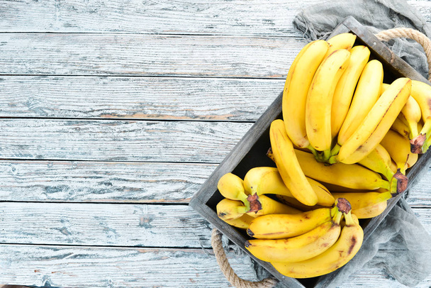 Fresh bananas in a wooden box. Top view. Free copy space. - Foto, immagini