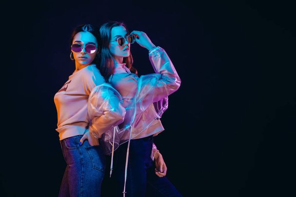 Stylish young women posing in neon light - Valokuva, kuva